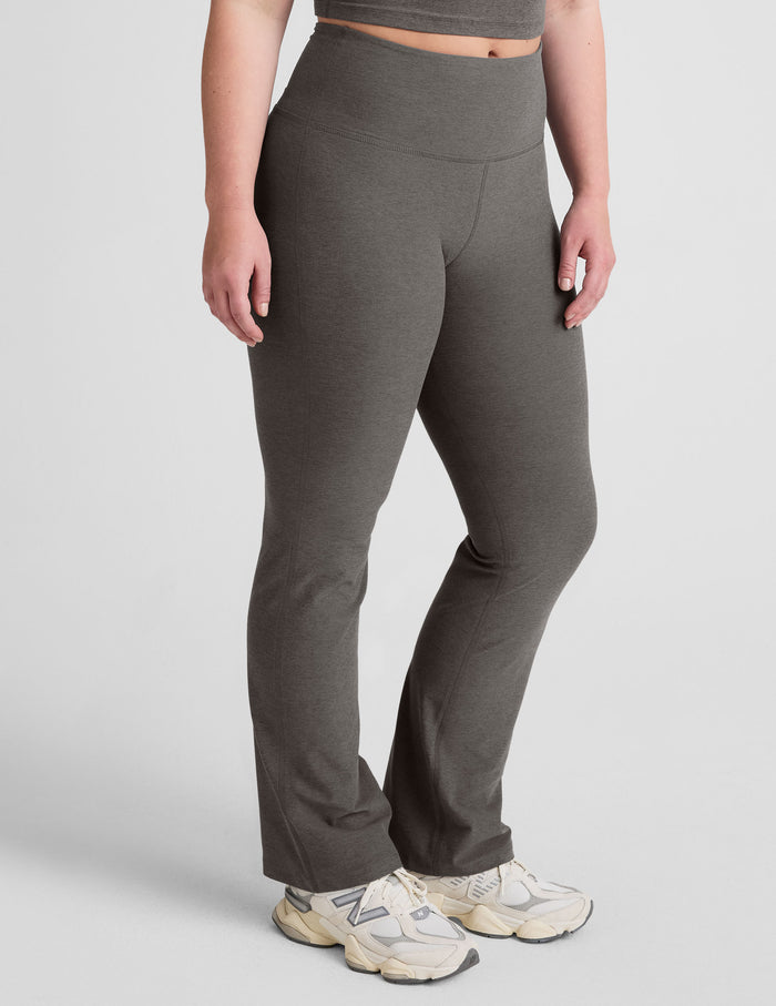 Gray Spacedye Practice High Waisted Bootcut Pant on a model, featuring a snug fit, wide waistband, and flared leg opening.