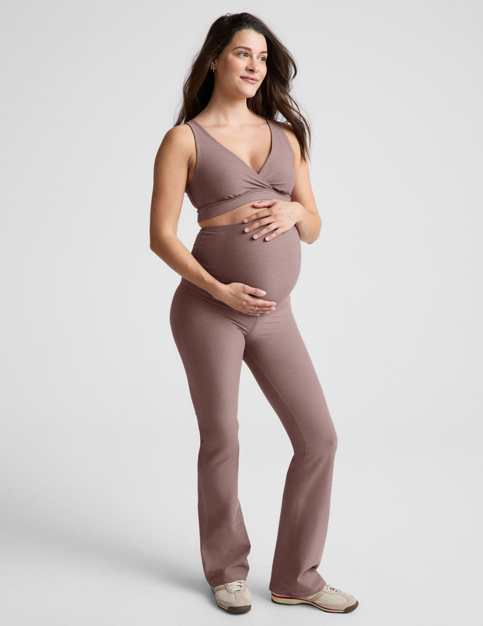 Pregnant woman in blush Spacedye Practice Maternity Pant with high waistband over bump and a matching v-neck top.