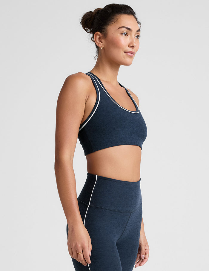 blue scoop neck racerback bra with white contrast trim.