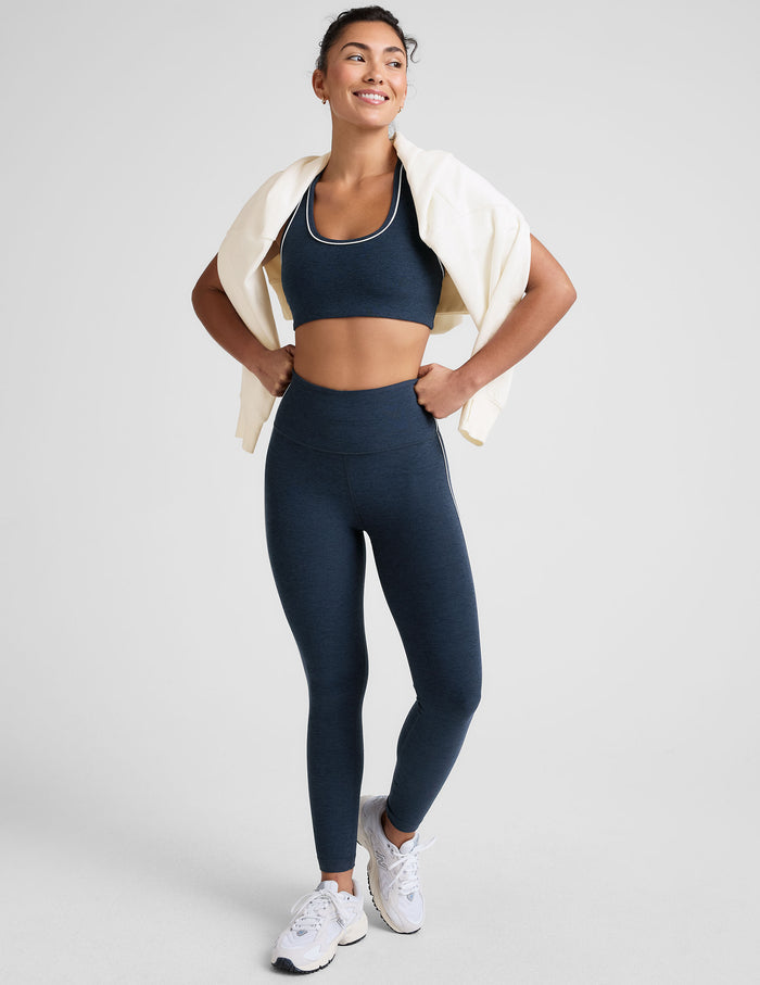 blue scoop neck racerback bra with white contrast trim.