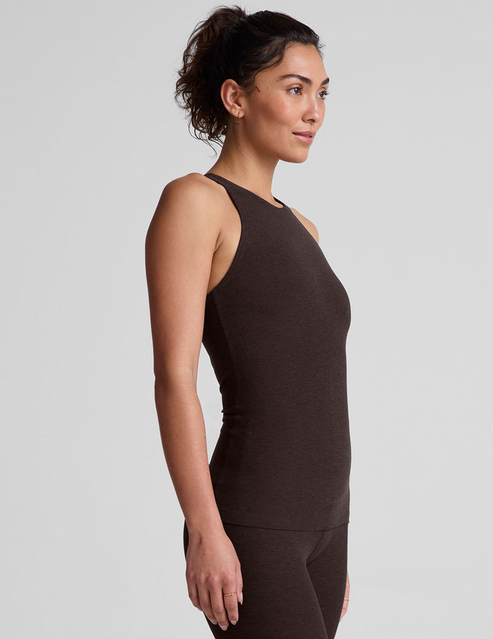 model wearing a brown high-neck racerback full length tank top against a plain background.