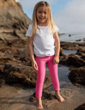 Girl wearing Pink Spacedye™ Toddler Legging with a high waistband paired with a white t-shirt.