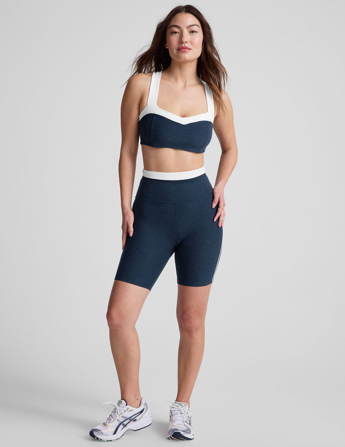 Navy marled Spacedye Trophy 5" Short on a model featuring a white high waistband and contrast side piping.