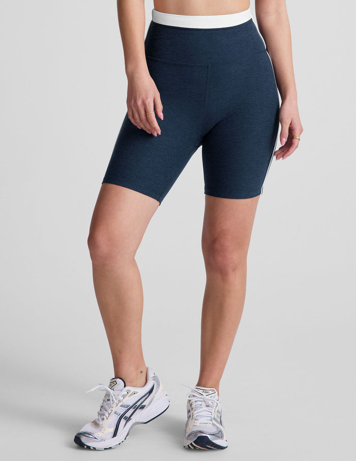 Spacedye Trophy 5" Short in navy blue marled fabric with a high white waistband and side piping on a model.