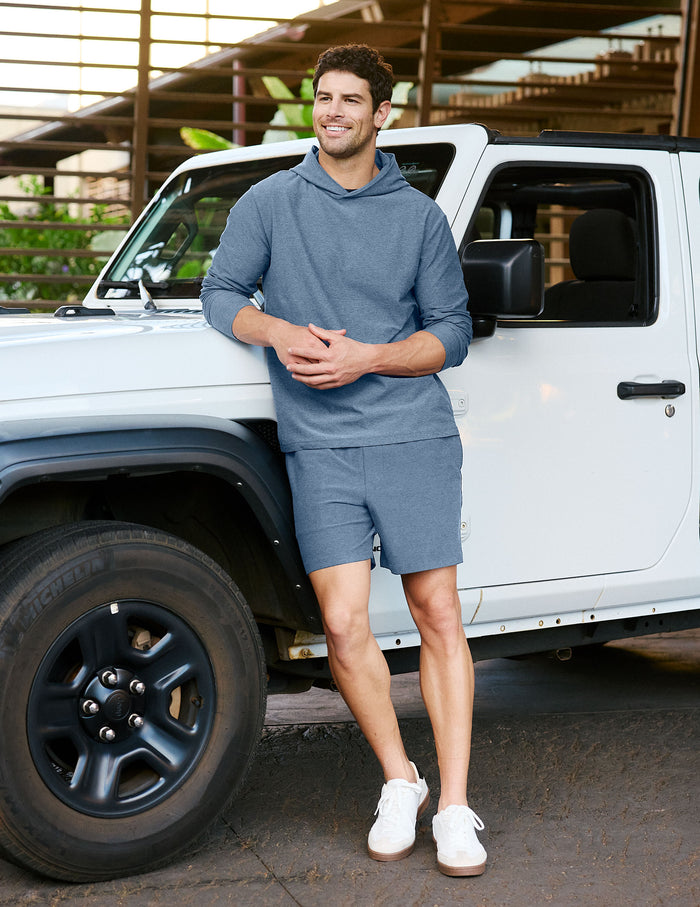 Man wearing Gray Spacedye™ Unlimited Men's Short leaning on a white vehicle, paired with a matching hoodie and sneakers.