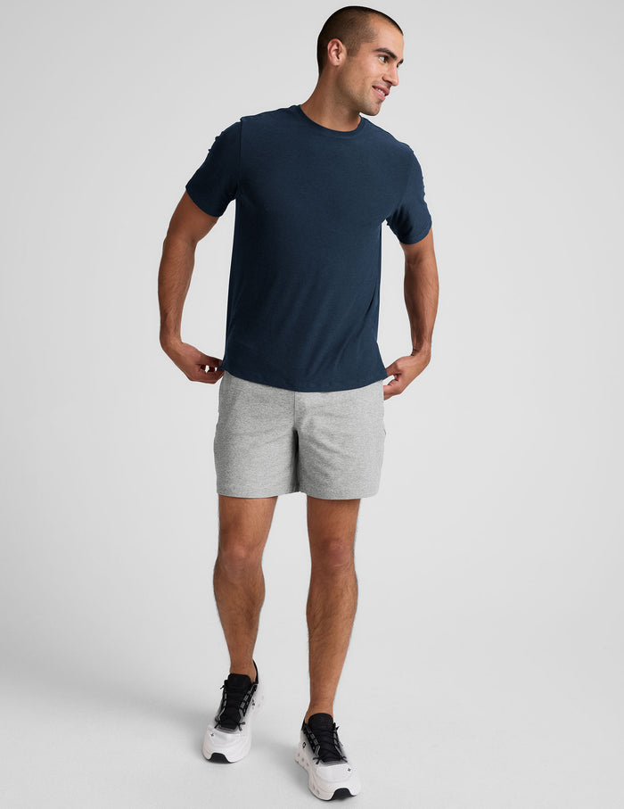 Light gray marled Spacedye Unlimited Men's Short with a 7" inseam and relaxed fit, styled with a navy t-shirt.