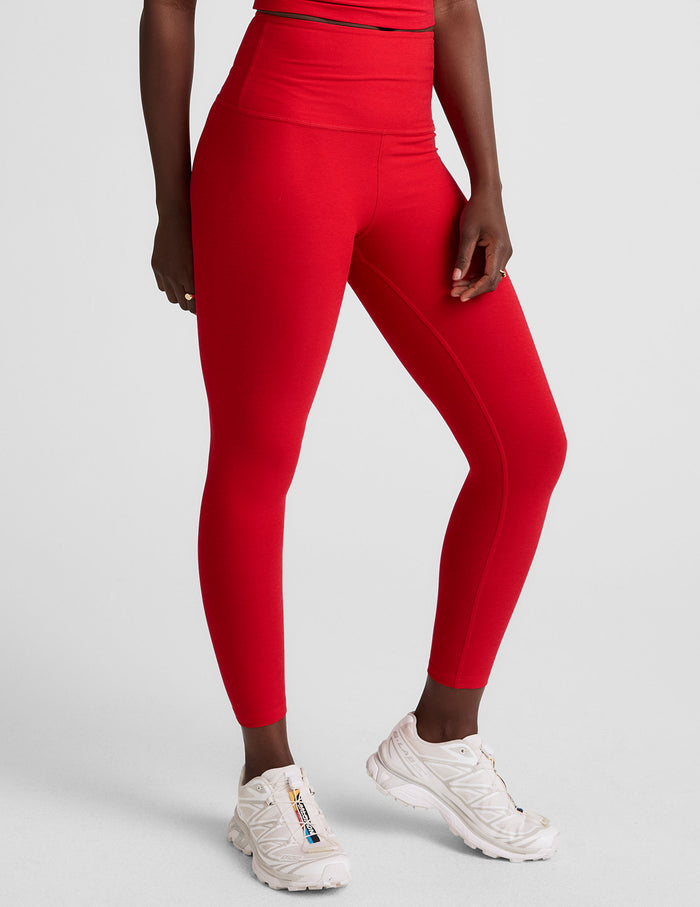 Red Spacedye Walk And Talk High Waisted Capri Legging on a model, featuring a snug, low calf fit and high-rise waistband.