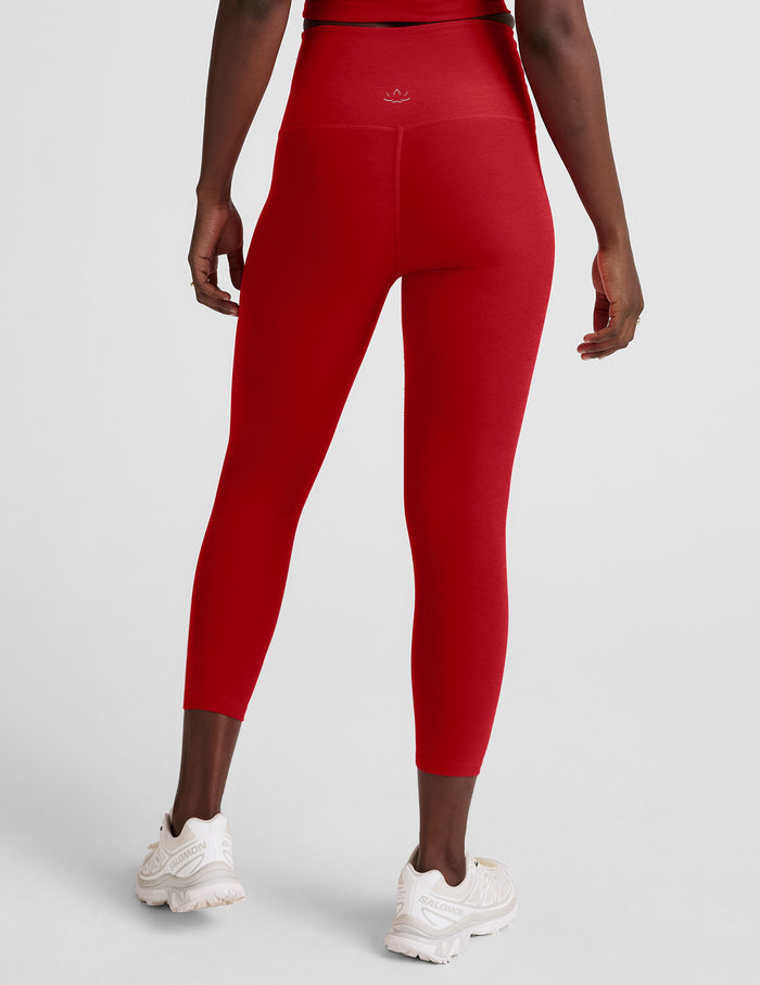 Rear view of the red Spacedye Walk And Talk High Waisted Capri Legging with a wide waistband and snug, cropped fit.