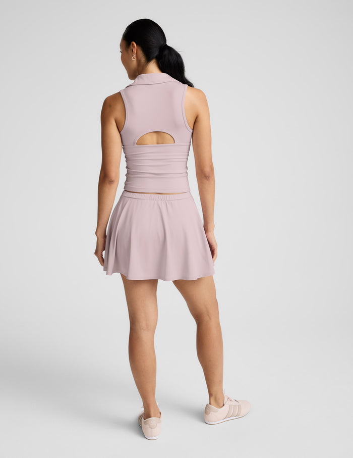 Rear view of the pink Sport Active Drawcord Mini Skirt featuring a relaxed A-line silhouette and an elastic waistband.