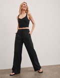 black mid rise jetstretch woven pants with cargo style pockets.