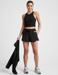 black shorts with a 2.5" inseam, encased elastic at waistband with drawcord​, self binding at hem edges​, side zipper pockets, and interior performance lining shorts​.