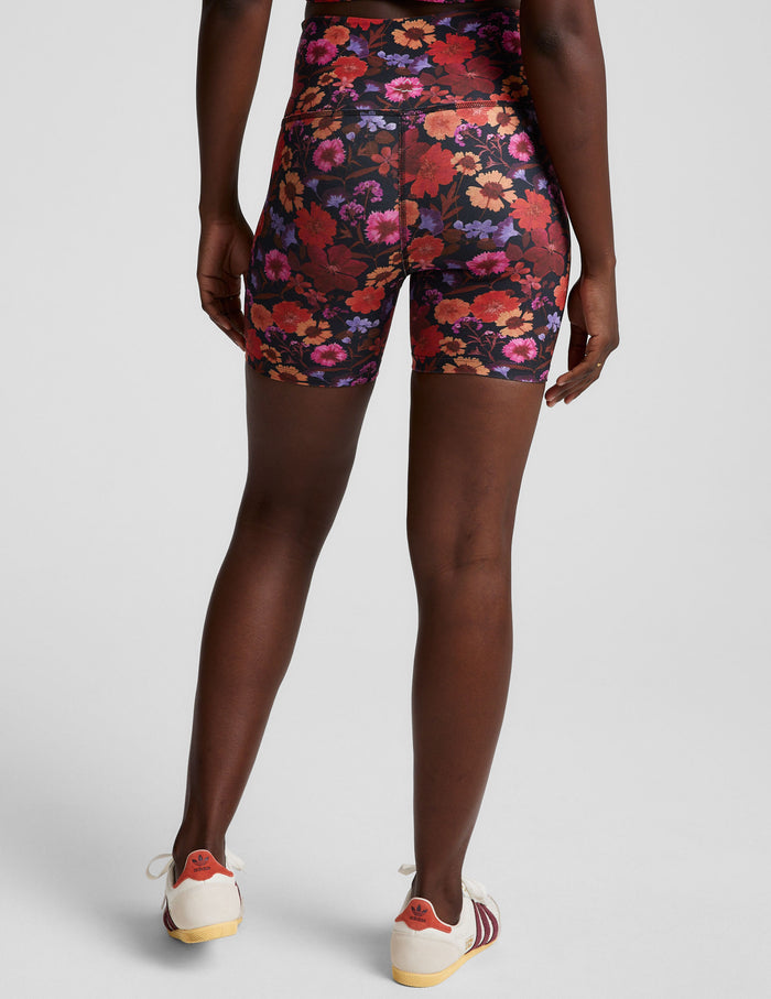 Back view of Summer Bouquet SoftMark Keep Pace Biker Short in a dark floral print with a high waist and 5-inch inseam.