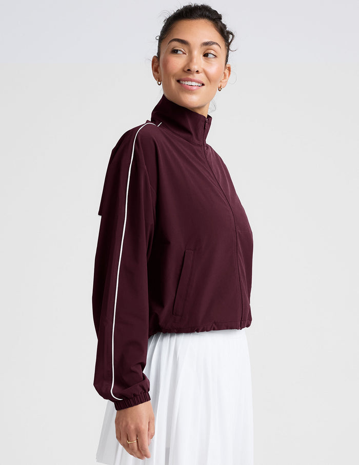 red zip-up jacket with white piping and pockets.