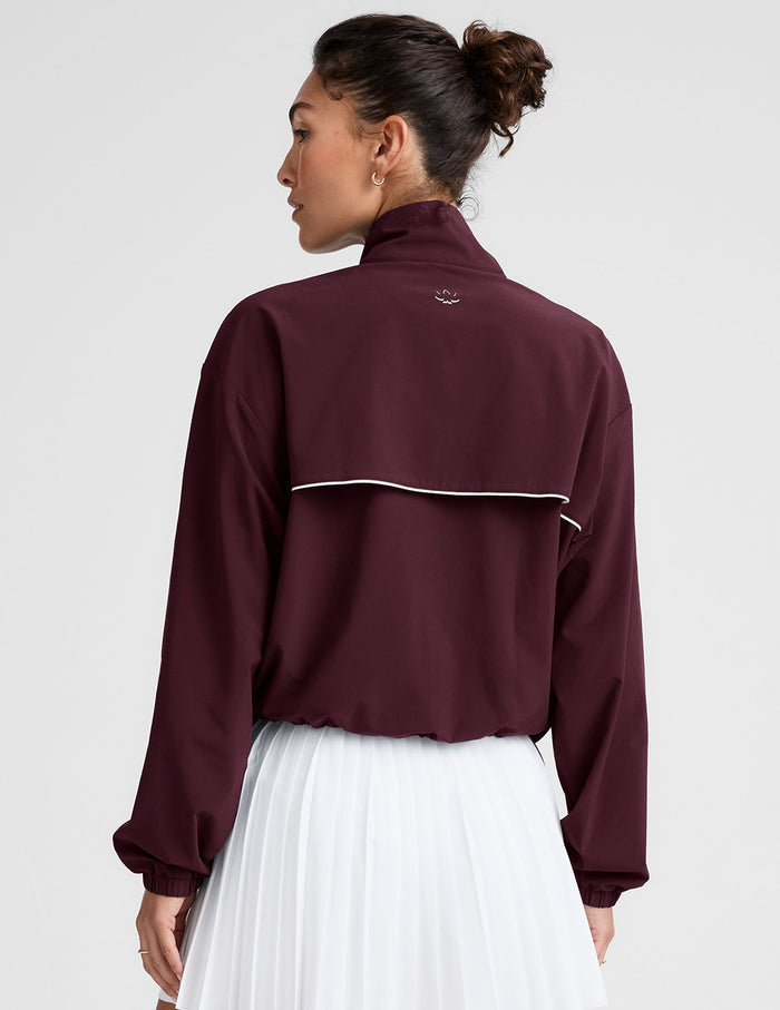 red zip-up jacket with white piping and pockets.