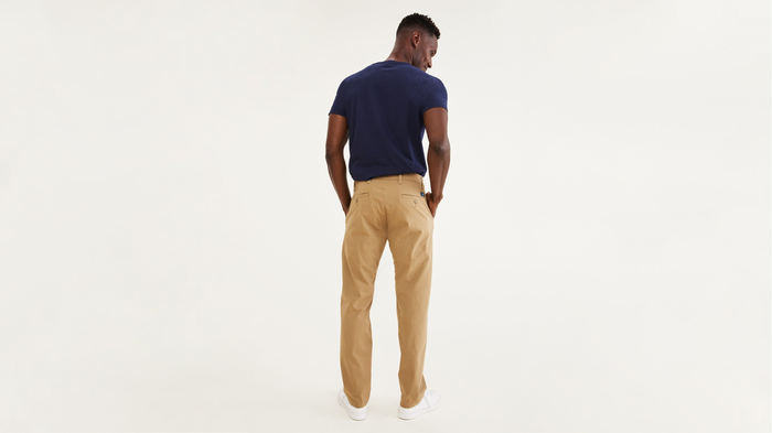 Back view of model wearing New British Khaki Ultimate Chinos, Athletic Fit.