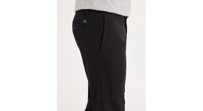 Side view of model wearing Black Ultimate Chinos, Athletic Fit.