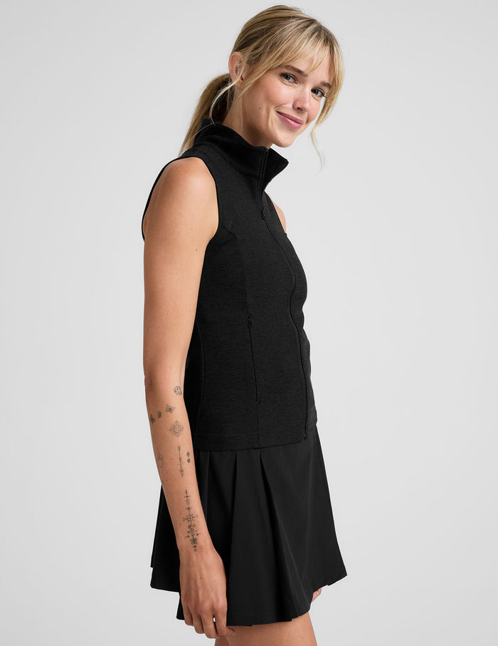 black zip-up vest with a mesh upper back detail.
