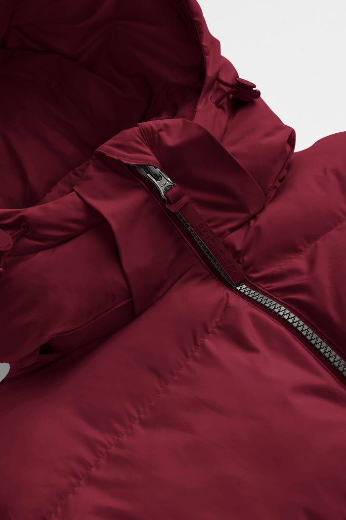red puffer coat on a light gray background.