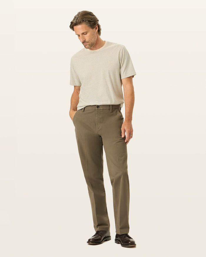 Front view of model wearing Dark Pebble Workday Khakis, Classic Fit.