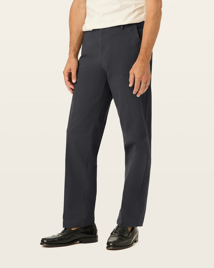 Side view of model wearing Black Workday Khakis, Classic Fit.