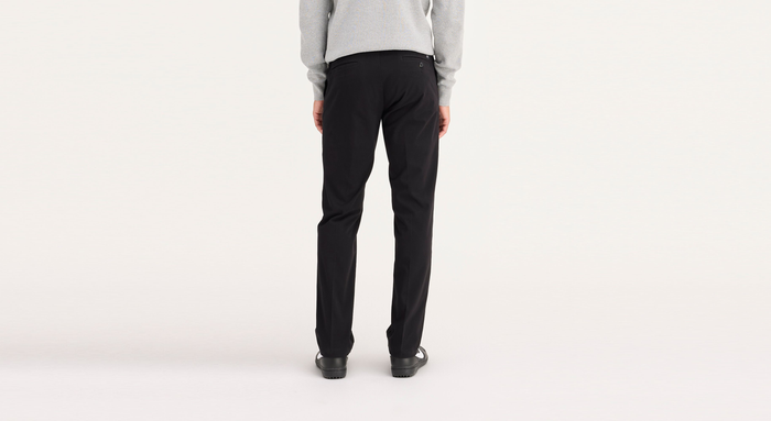 Back view of model wearing Black Workday Khakis, Slim Fit.