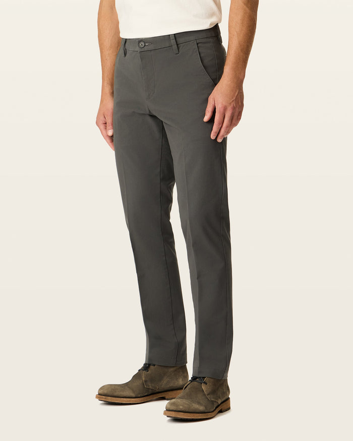 Side view of model wearing Storm Workday Khakis, Slim Fit.