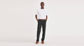 Front view of model wearing Black Workday Khakis, Straight Fit.