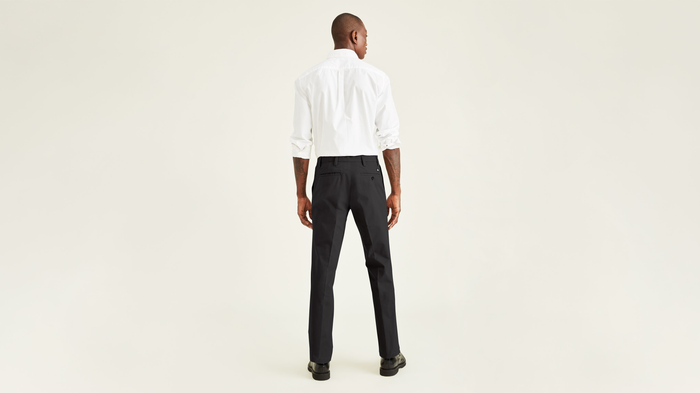 Back view of model wearing Black Workday Khakis, Straight Fit.