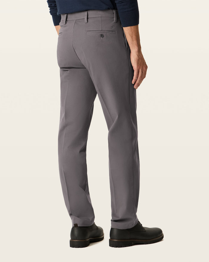 Back view of model wearing Storm Workday Khakis, Straight Fit.